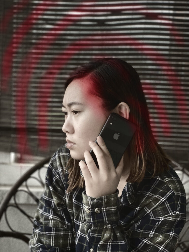 This image shows a person holding the smartphone and having radiation coming out. The goal for this illustration was to see the radiation which is red expanding around the person showing that there is radiation connecting to the smartphone. The red also shows the bad effect of the radiation. And the color choice for this was dark and sad showing the person is impacted by radiation.